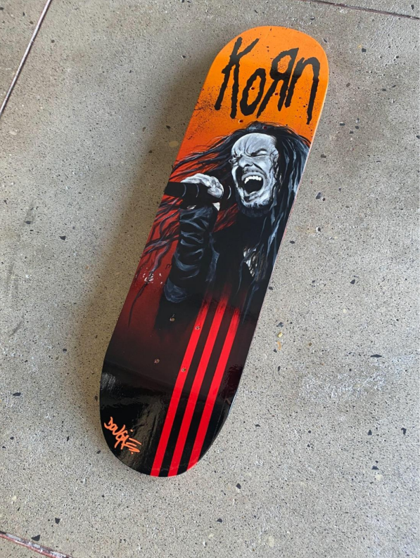 Custom skateboard deck featuring a black and white portrait of a screaming metal vocalist over a red and orange background with black stripes.